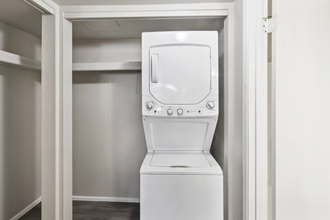 an empty laundry room with a washer and dryer